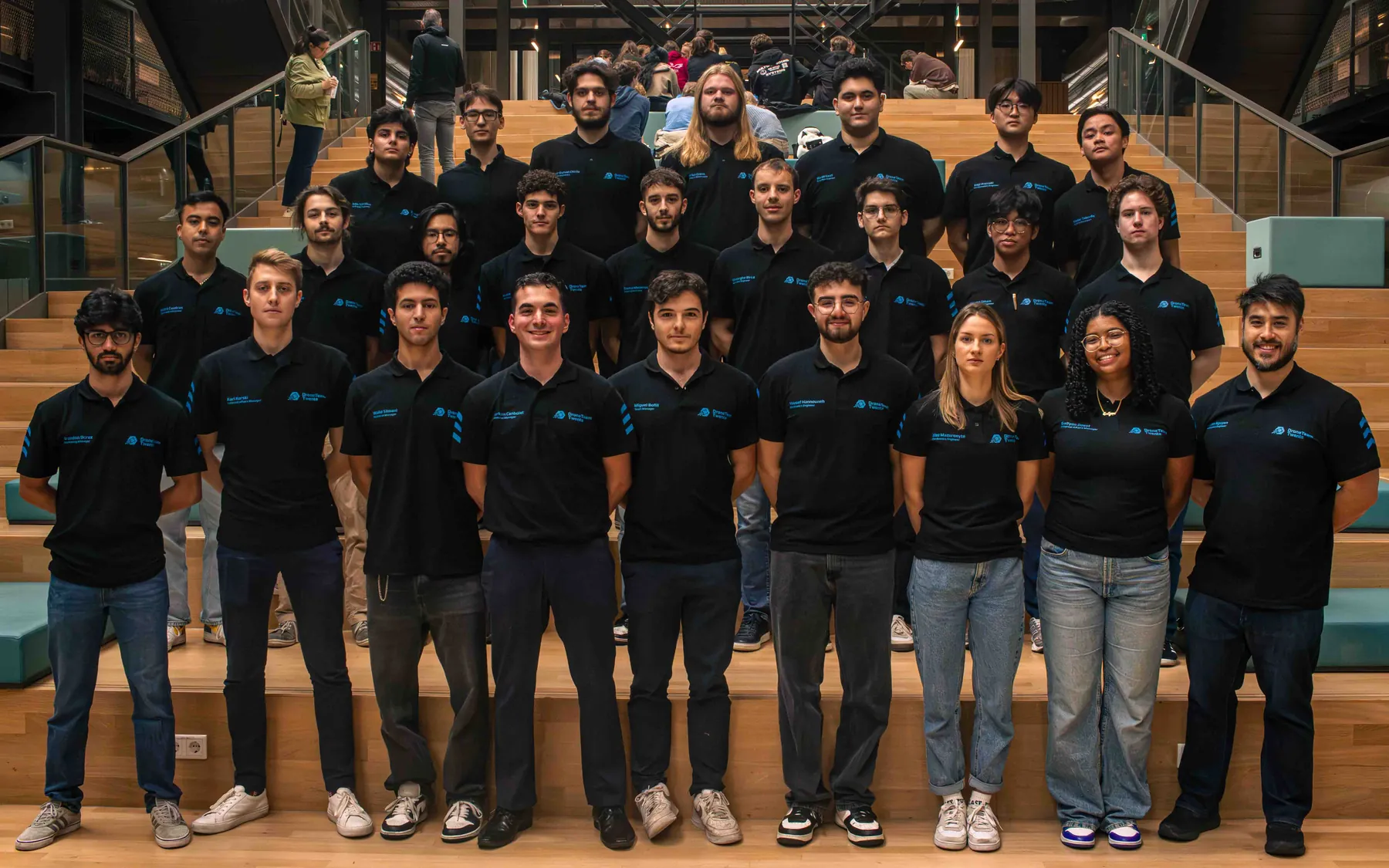 The 2025 to 2026 Drone Team Twente team on the stairs at the University of Twente